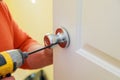 Man repairing the doorknob. closeup of worker& x27;s hands installing new door locker Royalty Free Stock Photo