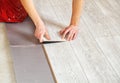 Handyman`s hands laying down laminate flooring boards Royalty Free Stock Photo