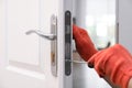 Handyman with screwdriver repairing door lock indoors, closeup Royalty Free Stock Photo