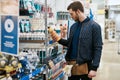 Handyman selecting a product at a hardware store Royalty Free Stock Photo