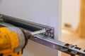 Handyman service in the process of assembling furniture kitchen closets and cabinets screwdriver and mounting Royalty Free Stock Photo