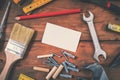 Handyman services home repair - blank business card with construction tools on wooden background Royalty Free Stock Photo