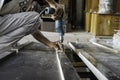 Handyman side view Close up of man drilling wood with a drill machine in a workshop, Close-up of carpenter using electric drill in Royalty Free Stock Photo