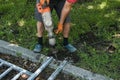 A handyman smashes an old concrete structure with an electric jackhammer. Royalty Free Stock Photo