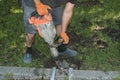A handyman smashes an old concrete structure with an electric jackhammer. Royalty Free Stock Photo