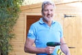 Handyman Standing Outside Garden Shed With Tools Royalty Free Stock Photo