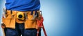 handyman tool belt on blue background with copy space Royalty Free Stock Photo