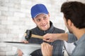 handyman using mallet to locate rubber seal into groove