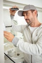 handyman wearing cap using screwdriver Royalty Free Stock Photo