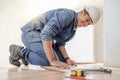 Handyman, wood flooring installation and happy at workplace, industry and home development vision. Black man Royalty Free Stock Photo