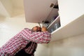 Handyman repair door on the cabinet in the kitchen