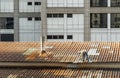 Handyman worker repairing tiles on the damaged factory roof