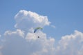 Hang-glider in the blue sky with clouds