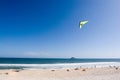 Hang glider flying over beach