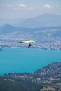 Hang-glider Instructor Flying in Hang-glider with Customer over Annecy Lake Through Mountain Landscape and Cities Royalty Free Stock Photo