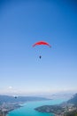 Hang-glider and Paraglider Flying over Annecy Lake Through Mountain Landscape and Cities Royalty Free Stock Photo