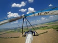 Hang glider pilot fly high above terrain