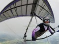 Hang glider pilot under the cloud