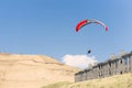 Hang Glider soars over beach lodging at Pacific City