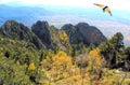 A Hang-Glider Soars the Sandia Mountains in Autumn Royalty Free Stock Photo