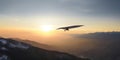 hang glider soars in the sky at sunrise amazing panoramic view Royalty Free Stock Photo