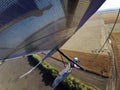 Hang glider wing over wheat field