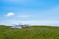 Hang gliders parked before taking a flight over the hills on a sunny day