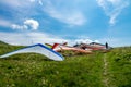 Hang gliders parked before taking a flight over the hills on a sunny day