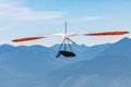 Hang gliding over valley farmlands and mountains Royalty Free Stock Photo