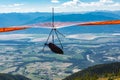 Hang gliding over valley farmlands and mountains