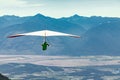 Hang gliding over valley farmlands and mountains Royalty Free Stock Photo