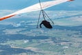 Hang gliding over valley farmlands and mountains Royalty Free Stock Photo