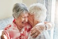 Hang onto those treasured friendships. two happy elderly women embracing each other at home.