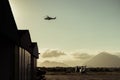 Hangar with helicopters at sunset.