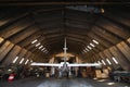 Hangar with modern airplane inside. Royalty Free Stock Photo