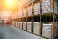 Hangar warehouse with rows of shelves with white polyethylene bags with finished factory production