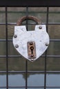 Hanged padlock on a fence of a bridge for love