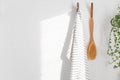 Hanged towel and shower massage brush wooden eco friendly bath equipment at white sunny bathroom