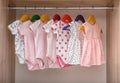 Hangers with baby clothes on rack Royalty Free Stock Photo