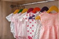 Hangers with baby clothes on rack in wardrobe Royalty Free Stock Photo