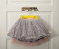 Hangers with lace skirts on white door