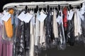 Hangers with clothes on conveyor at dry-cleaner`s