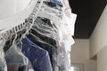 Hangers with clothes on conveyor at dry-cleaner`s