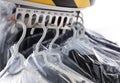 Hangers with clothes on garment conveyor at dry-cleaner`s