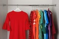 Hangers with different colorful clothes on rack Royalty Free Stock Photo