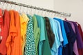 Hangers with different colorful clothes on rack Royalty Free Stock Photo