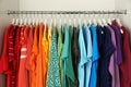 Hangers with different colorful clothes on rack Royalty Free Stock Photo