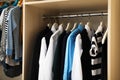 Hangers with teenage clothes on rack in wardrobe Royalty Free Stock Photo