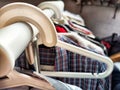 Hangers with a variety of clothes on a white rack. Home storage of clothes. Clutter. Littery. Declutter. Garage sale