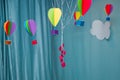 Hanging from above Colorful paper balloon with blue sky background and clouds. Origami made colorful air balloon cloud